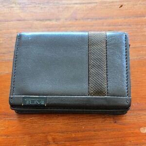 TUMI Dark Leather Wallet with Brown Accent